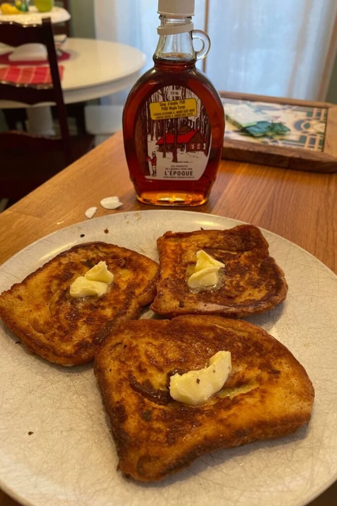 Easy French toast recipe with butter on top served with maple syrup