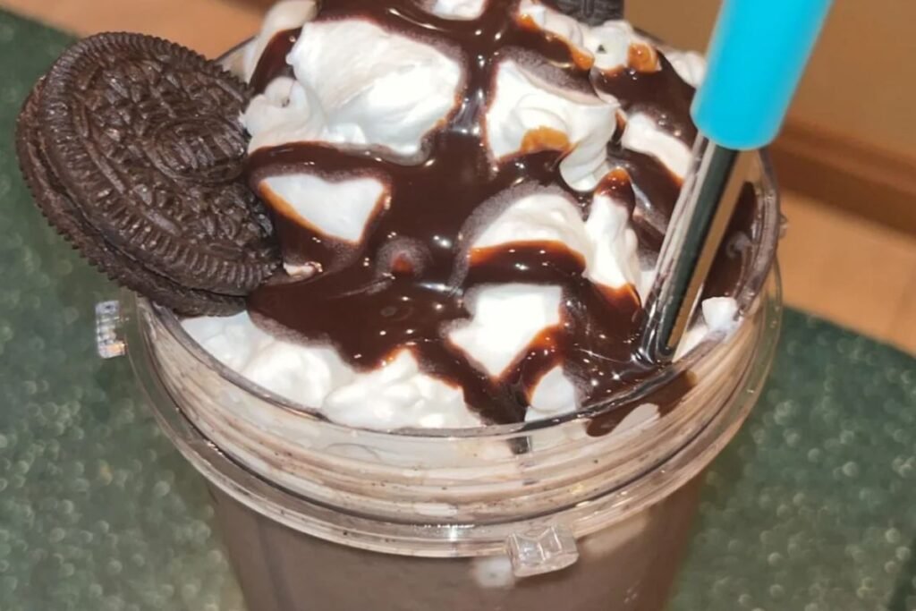 Creamy homemade Oreo milkshake topped with whipped cream, chocolate syrup, and Oreo cookies in a glass jar