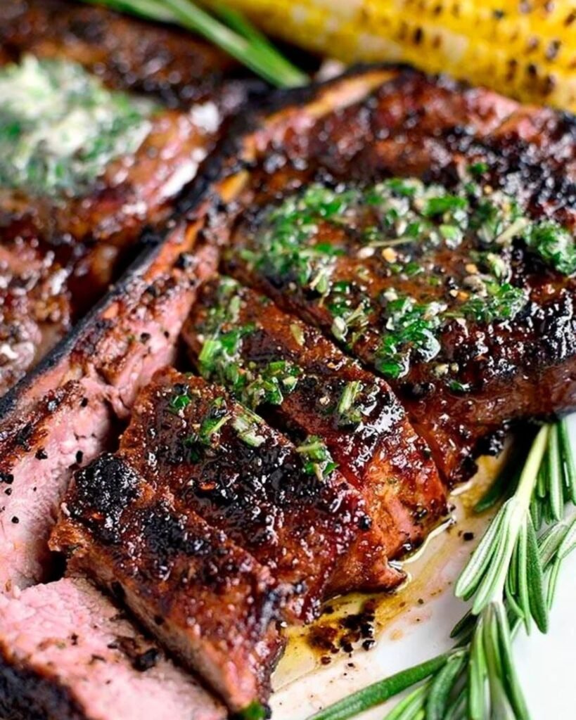 Perfect grilled steak with grill marks cooking on a barbecue grill
