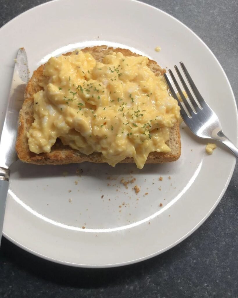 Perfect scrambled eggs soft and creamy served on plate